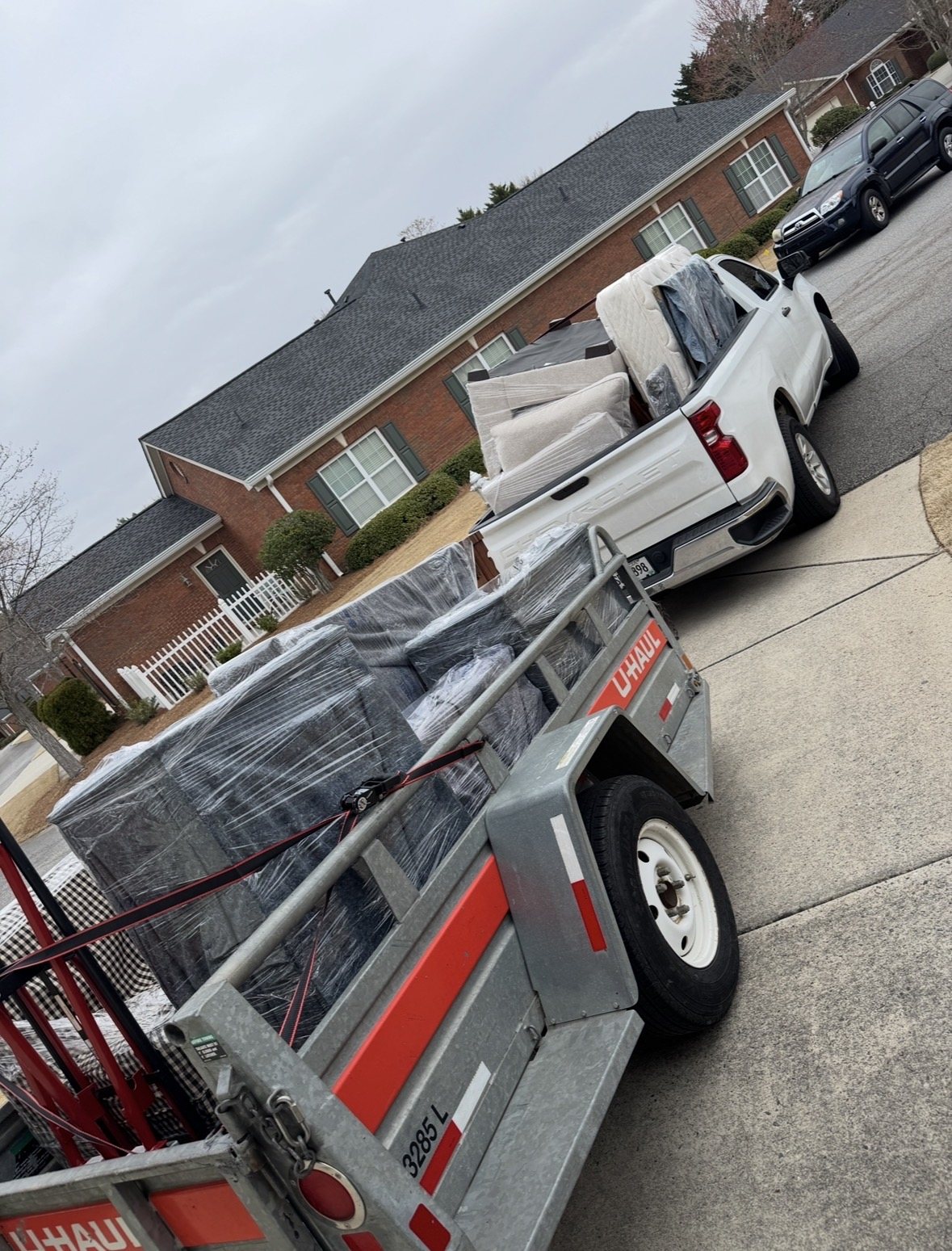 Wrapped furniture loaded on a trailer and Atlanta Move & Dump truck during a move